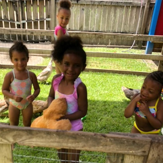 Small children playing with ponya duck.